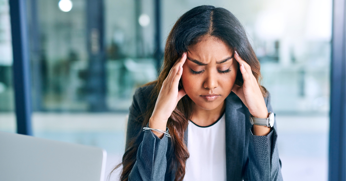 Stressed woman holding her head
